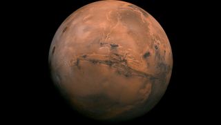 Mars appears rusty red against the black background of space.