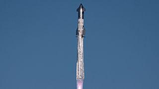 closeup of a huge silver rocket flying through a blue sky