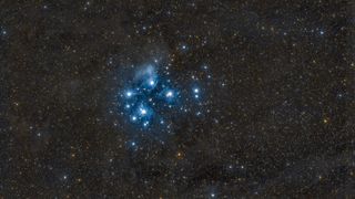 a cluster of bright blue stars against a background of stars.