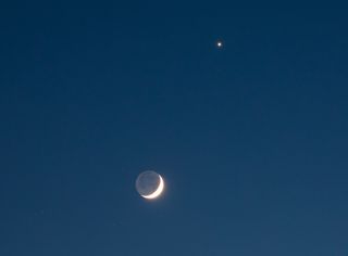 waxing crescent moon with earthshine and venus above