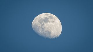 low angle view of the moon against blue sky