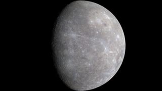 mercury appears as a gray and cratered planet against the black backdrop of space.